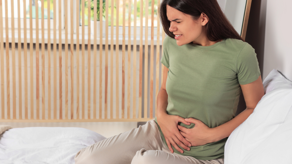 Pregnant woman doing stretches to relieve pelvic pressure