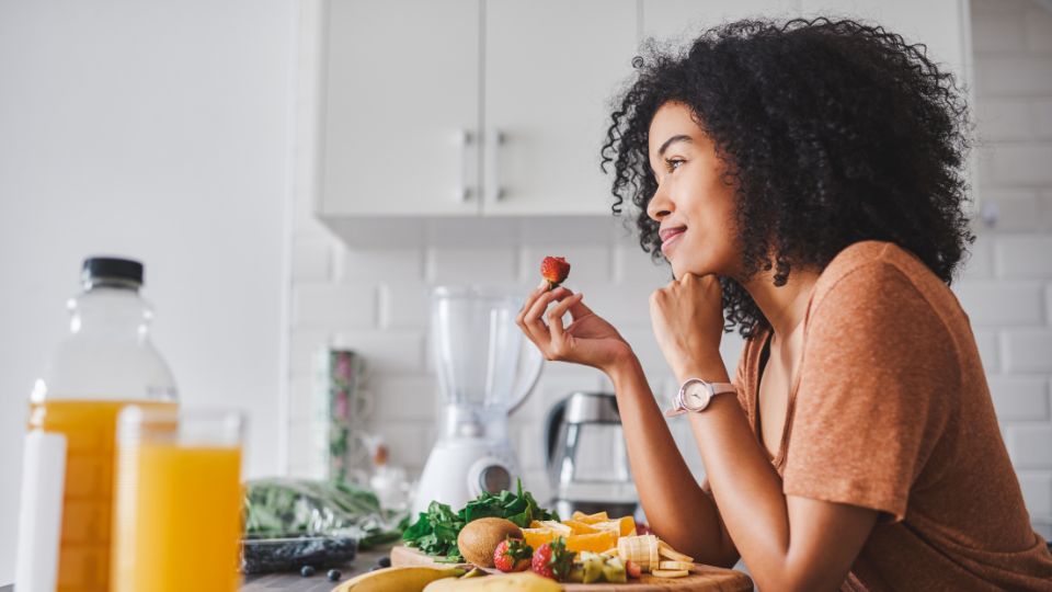 Pregnant woman eating a spicy dish.