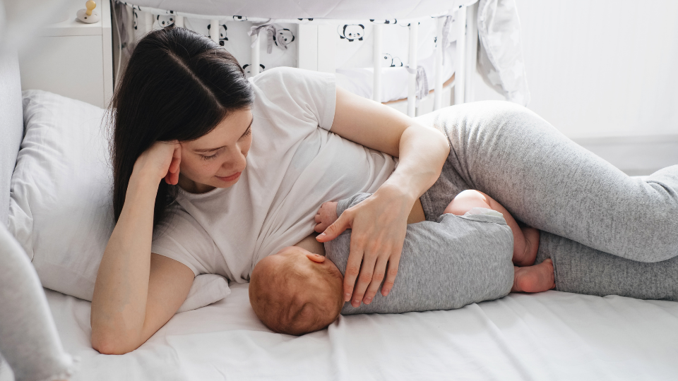 Parent feeding a baby while establishing a feeding routine