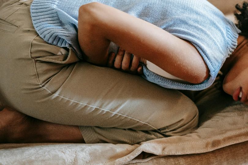 practicing self-care during her period with a warm drink